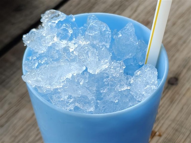 A blue plastic sup with ice in