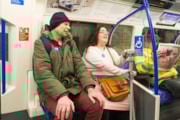 TfL Image - Customers using Please offer me a seat badges and priority seating: TfL Image - Customers using Please offer me a seat badges and priority seating