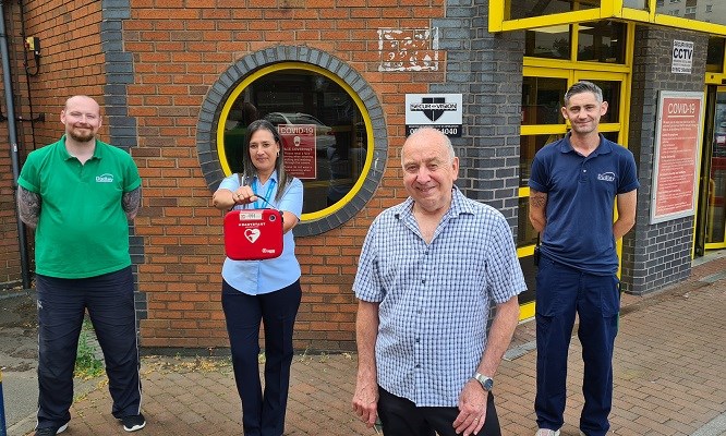 Leisure centre staff with customer who they helped