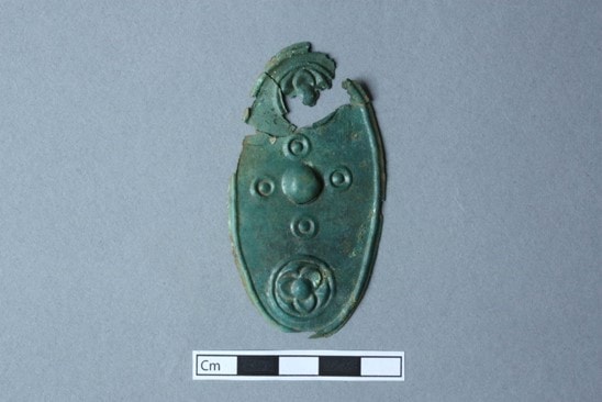 A miniature shield votive