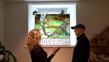 Marta Sienkiewicz presenting her stained glass artwork to a visitor to Strathnaver Museum (c) Eilidh Ross