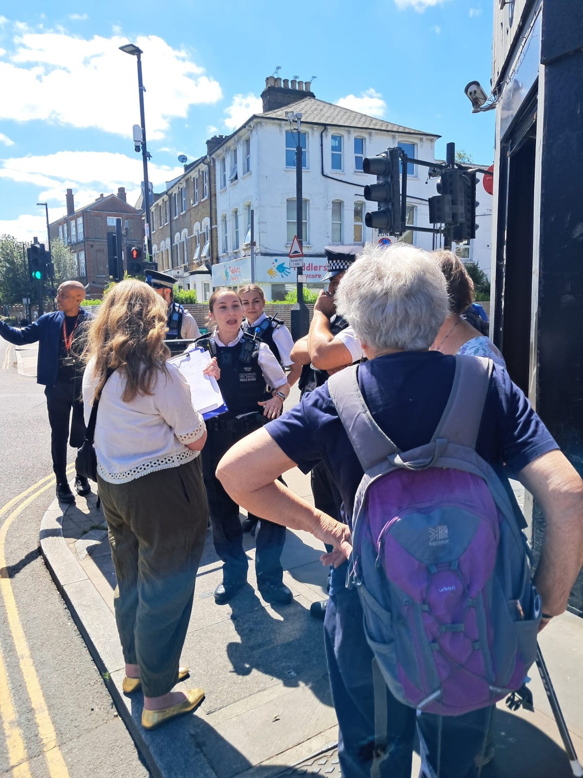A police officer talking to local people on a community walkabout