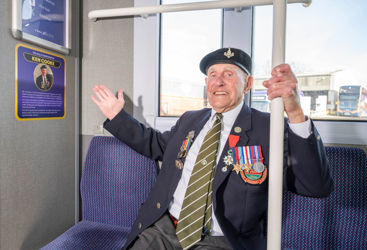 Ken Cooke inside bus with tribute plaque