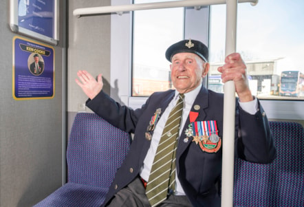 Ken Cooke inside bus with tribute plaque