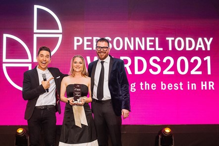 Ruth Busby receives her HR Director of the Year Award from Personnel Today Editorial Director Rob Moss, right, and comedian Russell Kane