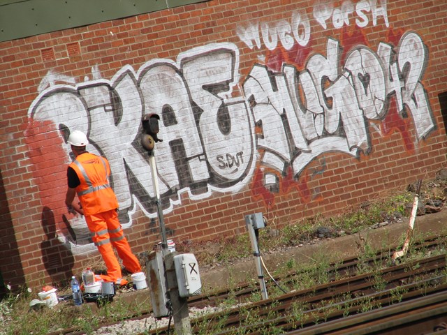 Graffiti is painted out - Bristol Temple Meads: Bristol Temple Meads - one mile clean up either side of the station, 31 July 2006

