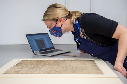 Library Conservator Lizzie Fuller installs a Timothy Pont map (1596)  - detailing most of the drainage basin of the River Clyde. Credit: Neil Hanna