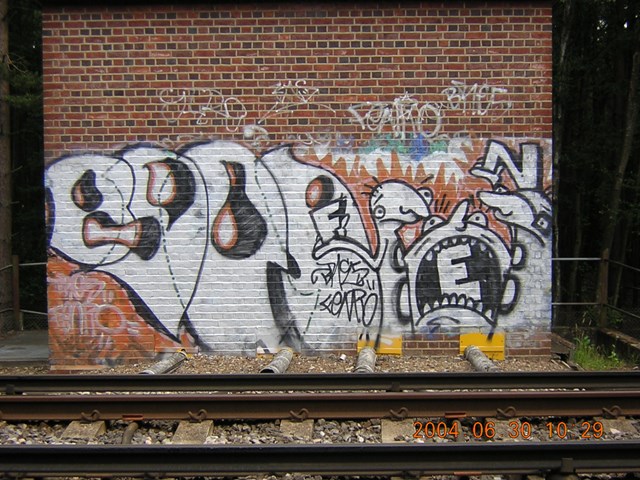 Graffiti vandalism track-side - Chiswick, West London: Vandalism of a railway building beside the track.
Photo taken May 2006.