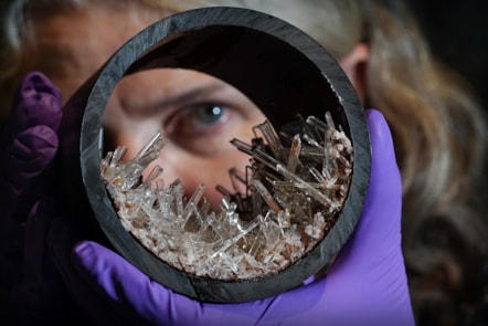 Dr Rachel Walcott, Principal Curator of Earth Systems, with a plastic pipe containing gypsum crystals, image copyright Stewart Attwood