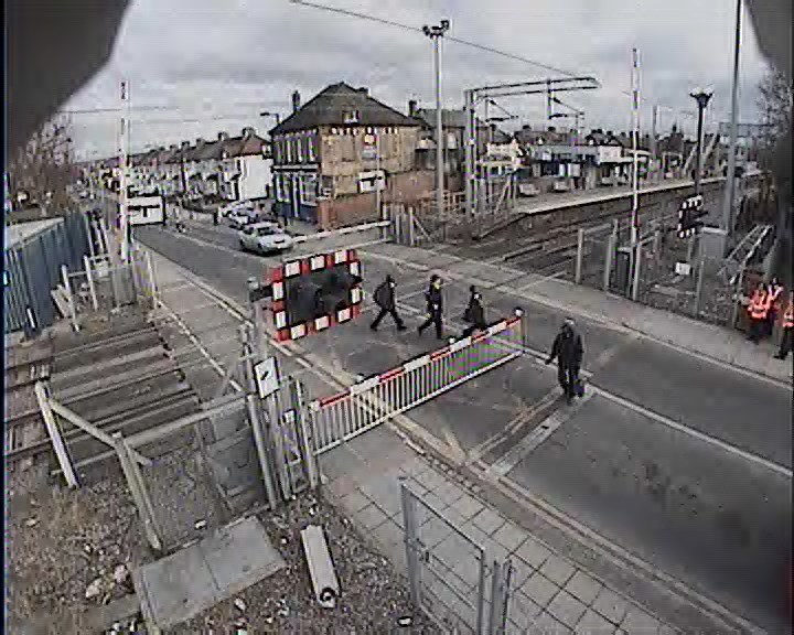 Kids run the risk at Enfield Lock: Schoolchildren run the risk at Enfield Lock level crossing - even as Network Rail safety staff and British Transport Police (in high-vis, right) patrol the crossing.