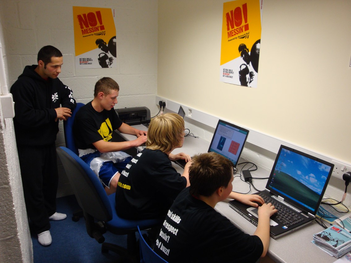 New education suite, Corby boxing gym: Troy James and young boxers try out internet-enabled laptops in the new education suite at Corby Olympic Amateur Boxing Club.