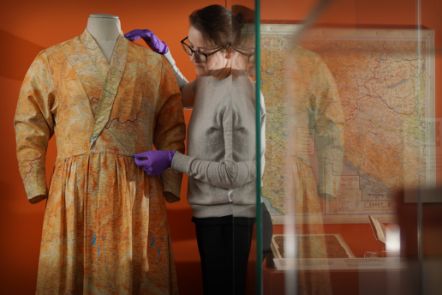 Assistant Textile Conservator, Stella Gardner adjusting a silk dress made from escape and evade maps used during the Second World War, on loan from Worthing Museum and Art Gallery. Image © Stewart Attwood