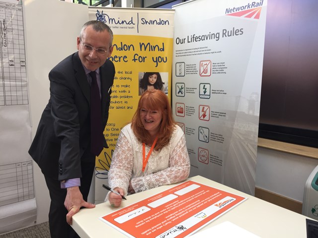 Signing of the mental health awareness pledge in Swindon: Mark Langman (Network Rail's managing director of the Western route) signs the company's mental health awareness pledge with Dr Donna Lovell (acting CEO of Swindon Mind).