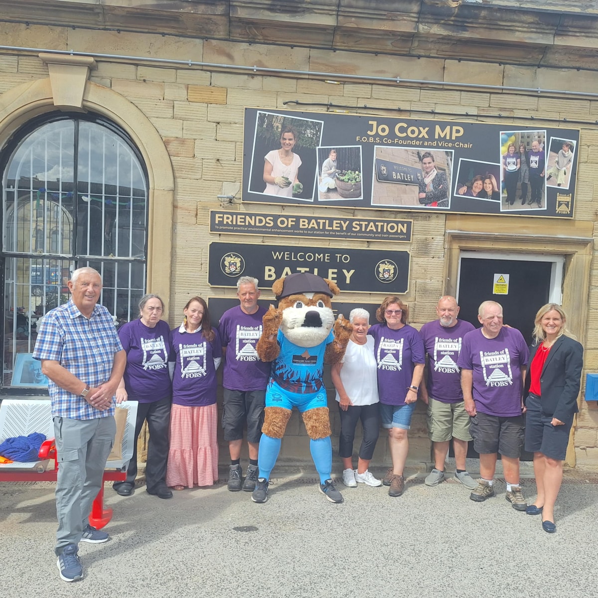 An image of Friends of Batley Station volunteers and Jo Cox's family with the new memorial