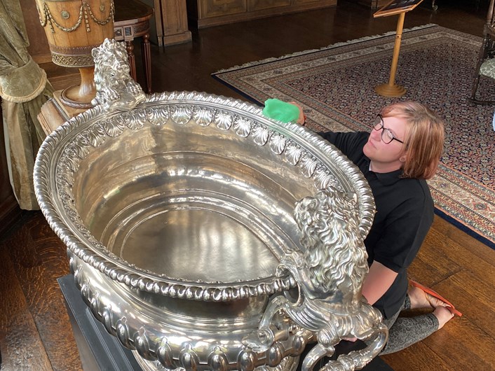 Silver wine cooler: Temple Newsam visitor assistant Rebecca Allott polishes the house's spectacular giant silver wine cooler ready to welcome visitors.