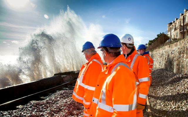 The secretary of State for Transport, Patrick McLoughlin, witnesses the force of the sea at Dawlish on Friday with Network Rail's route managing director Patrick Hallgate and future chief executive Mark Carne