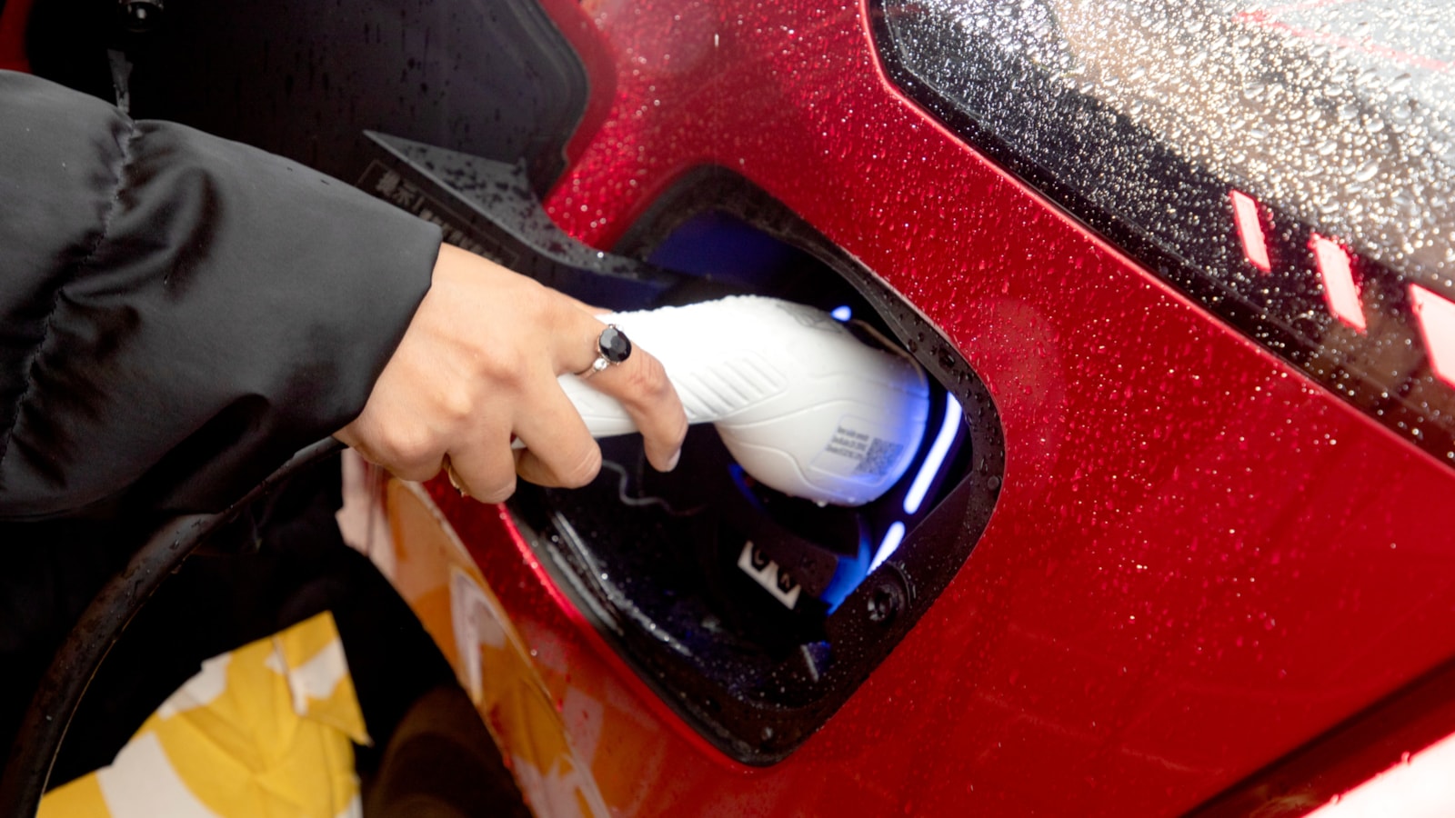 Motability Scheme customers hand charging electric car cropped-2