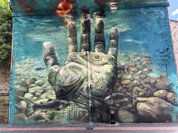 Mural Penny Pocket Park: The water scene which forms part of the mural works as a symbol for the River Aire running through the city not far from the park itself.