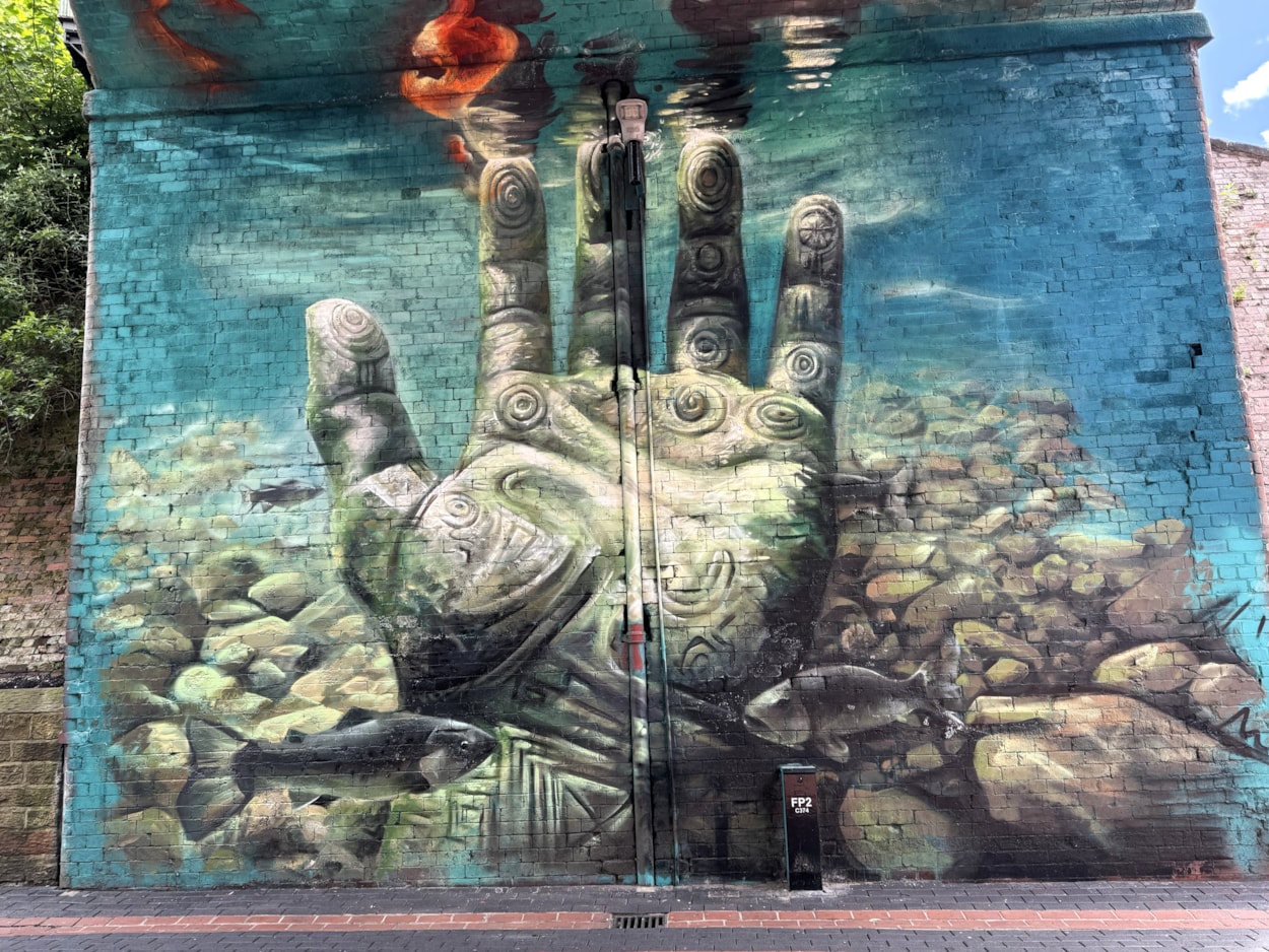 Mural Penny Pocket Park: The water scene which forms part of the mural works as a symbol for the River Aire running through the city not far from the park itself.