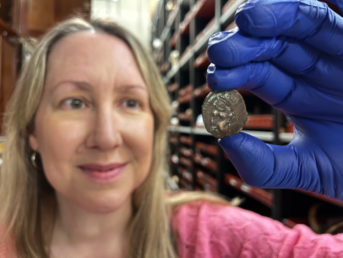 Ancient coin: Kat Baxter, Leeds Museums and Galleries' curator of archaeology and numismatics with the ancient coin now at Leeds Discovery Centre.
The astonishing discovery, handed to an unwitting local bus driver in the 1950s, was produced by Carthaginians, part of the Phoenician culture, in the Spanish city of Cadiz during the 1st Century BC and has now kindly been donated to Leeds Museums and Galleries.