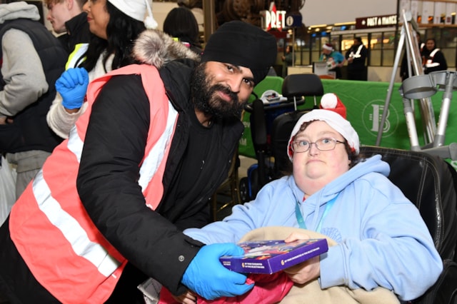 Guests enjoying gifts at Birmingham New Street Christmas Eve meal 2024: Guests enjoying gifts at Birmingham New Street Christmas Eve meal 2024