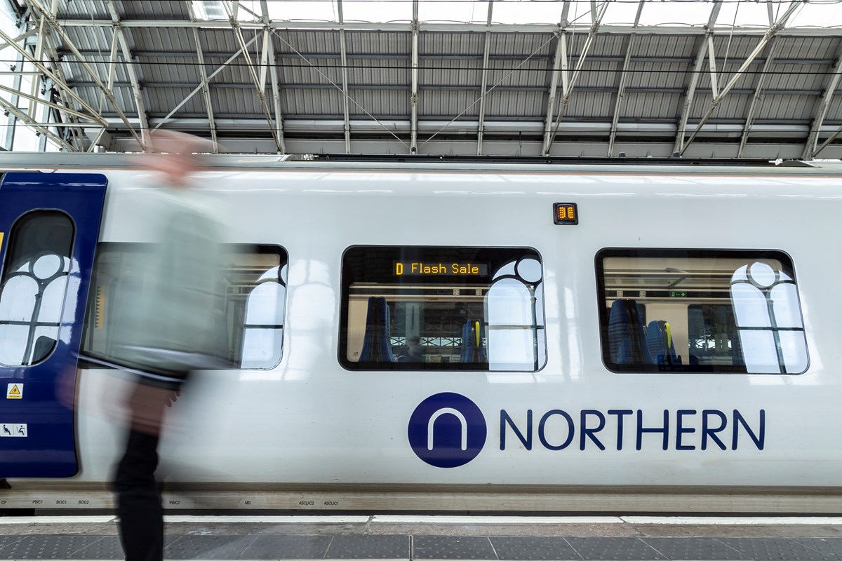 Image shows passenger alongside Flash Sale branded Northern train