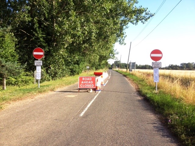 Signs on the approach to Lolham level crossing which is now one-way