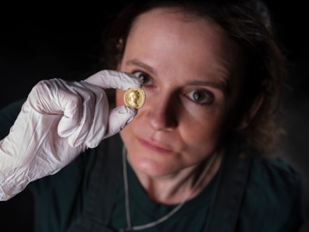 Conservator Bethan Bryan examines the gold Aureus of Trajan. Image © National Museums Scotland (4)