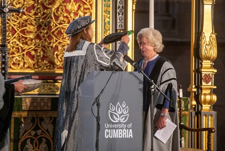 Vice Chancellor of University of Cumbria placing tudor bonnet on head of Honorary Fellows Claire Hensman during graduation ceremony