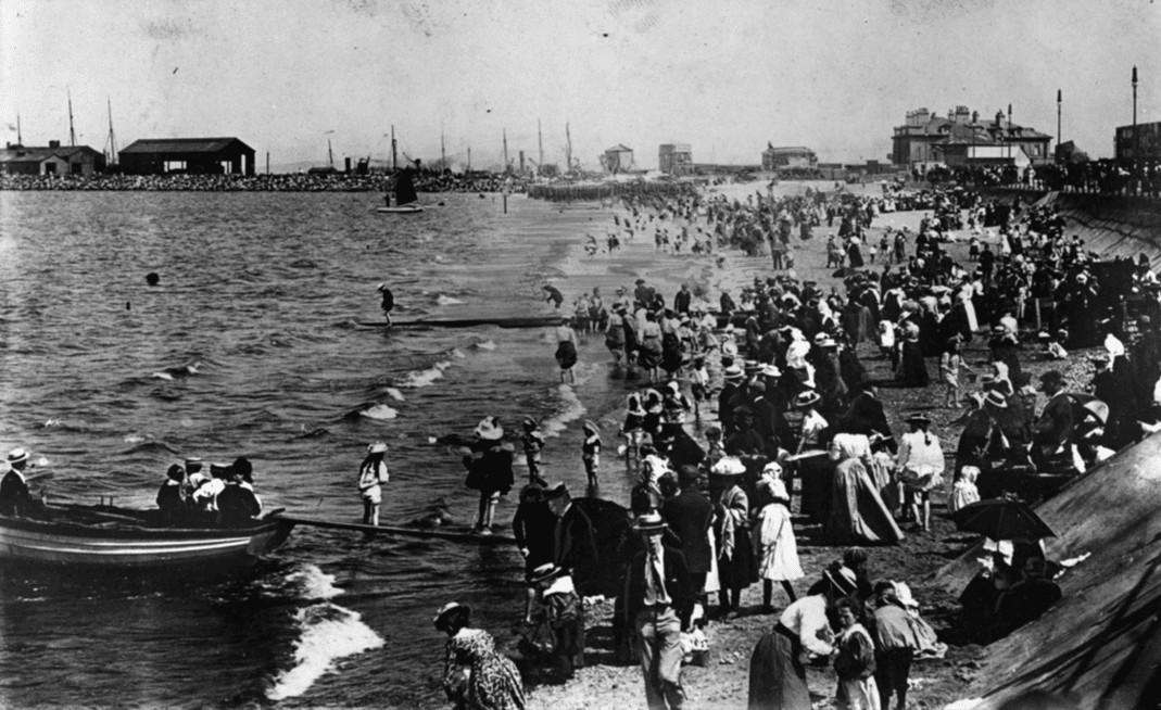 West End beach, Morecambe, with a view of Morecambe harbour and the old Midland Hotel in the distance. Taken circa 1910.
