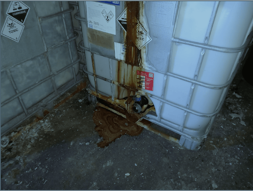Brown sludge leaked from IBC containing waste