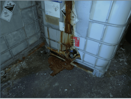 Brown sludge leaked from IBC containing waste