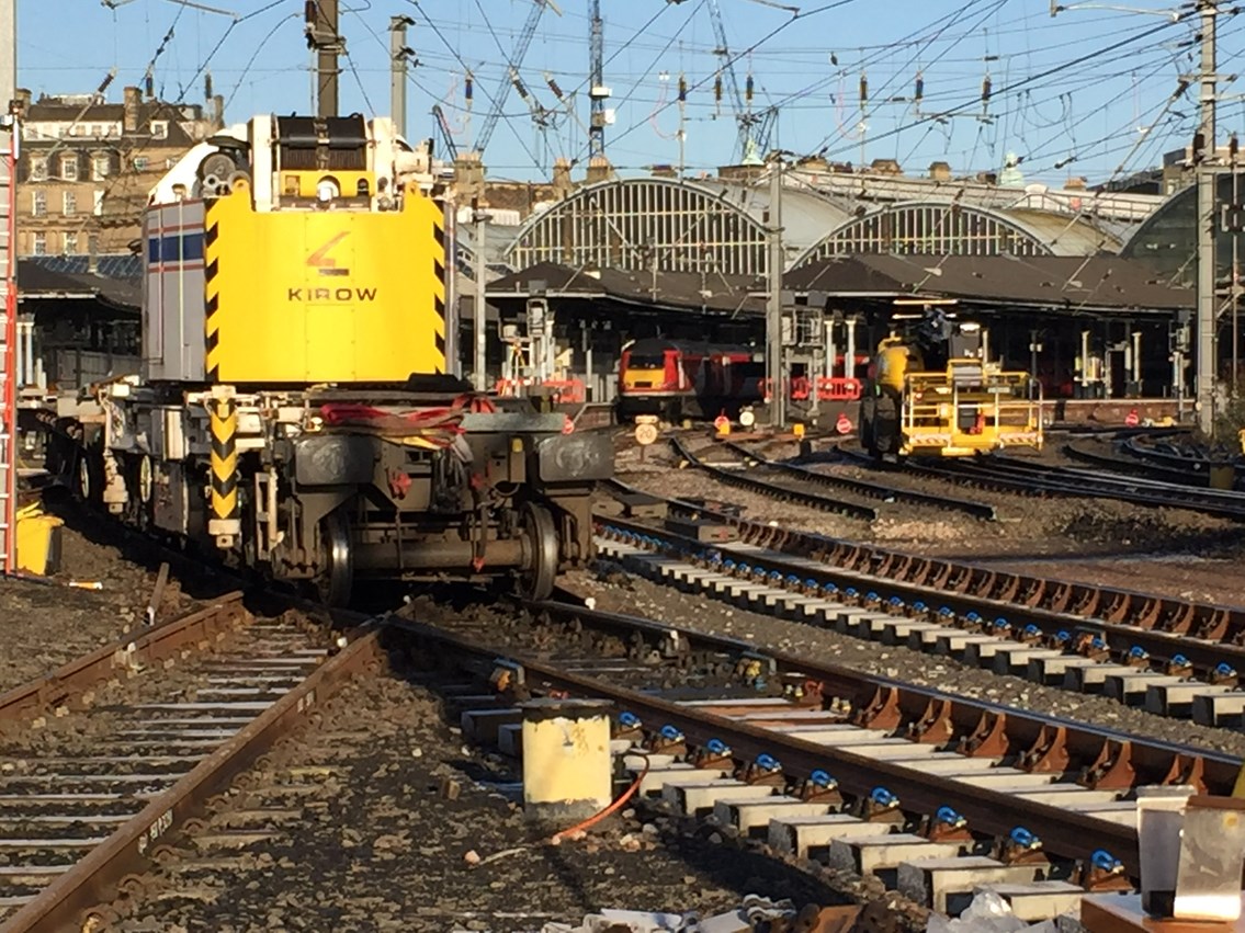 Train services back to normal as major improvement work at Newcastle station completes: Kirow bringing the panels from the station storage area to be placed in position with a VTEC train in the station