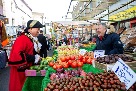 The Mayor and John chat over a fruit and vegetable stall