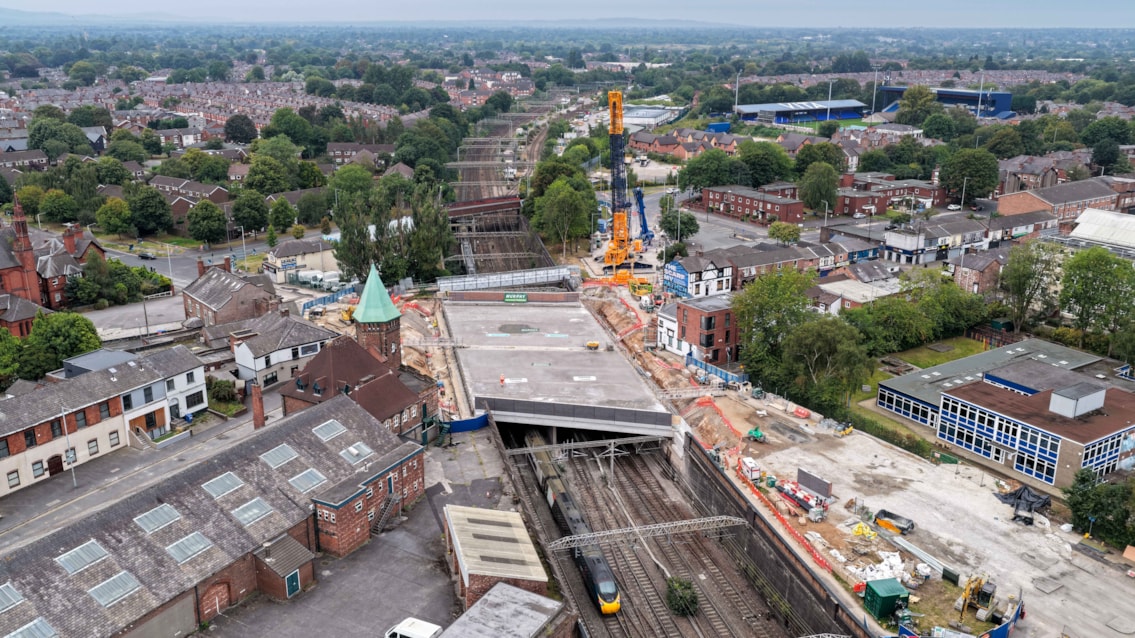 West Coast Main Line reopens after £43m upgrades across three counties: Drone image of first trains running under new Greek Street railway bridge after 21-day closure through Stockport August 2025