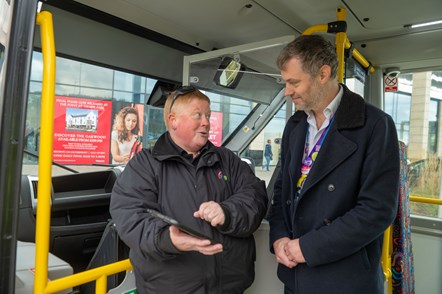 FlexiBus driver Sarah shows Cllr Carlill how to book a trip on the app