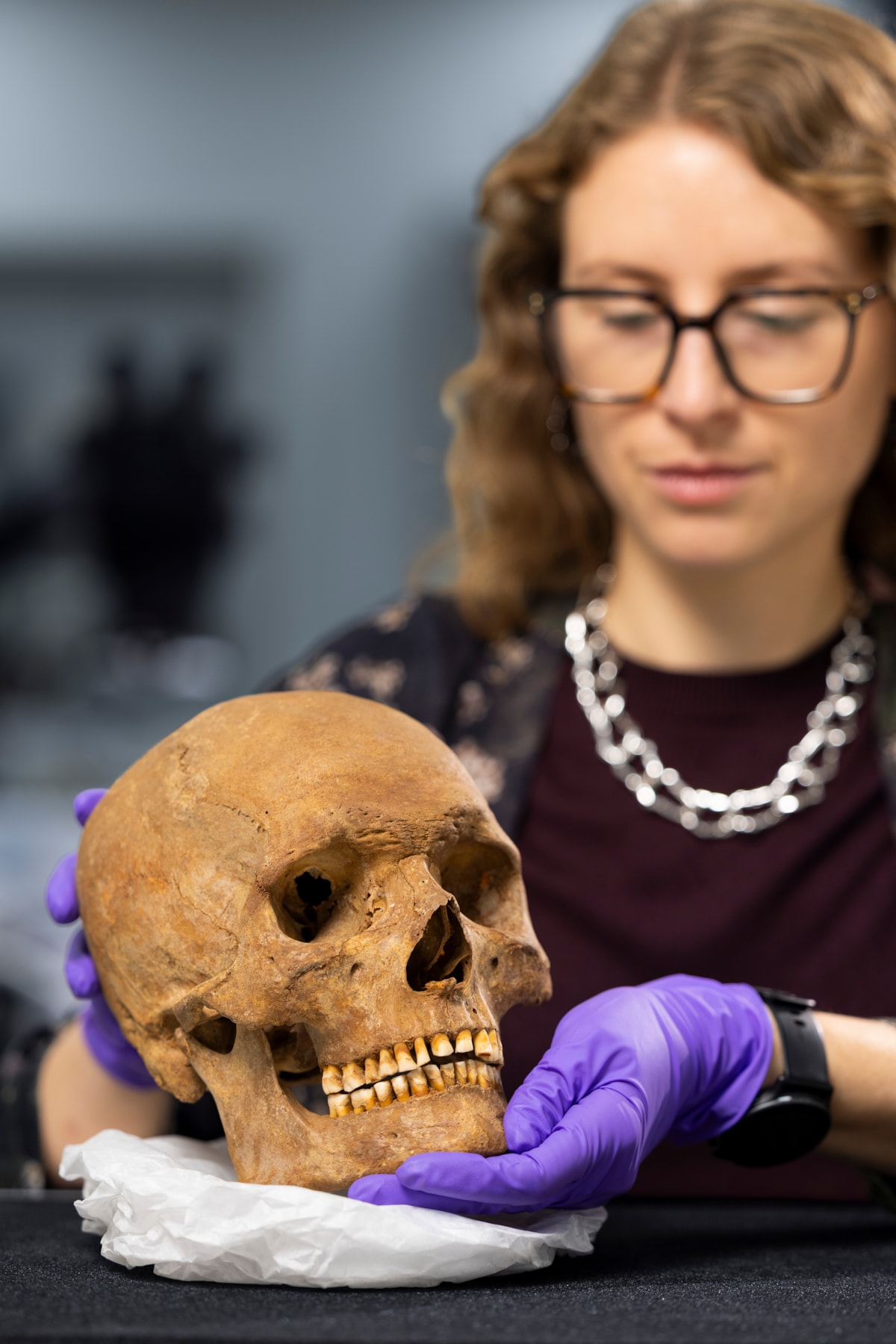 Dr Jess Thompson examines the skull of a man from Roman Scotland. Photo © Duncan McGlynn (2)