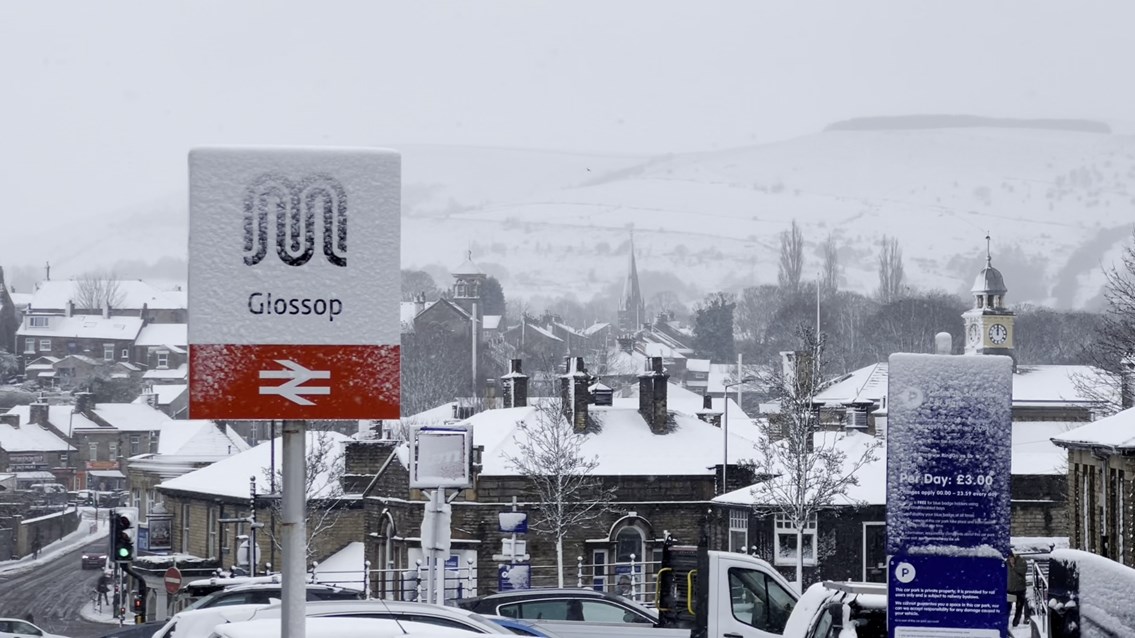 Glossop station sign during blizzard March 2023