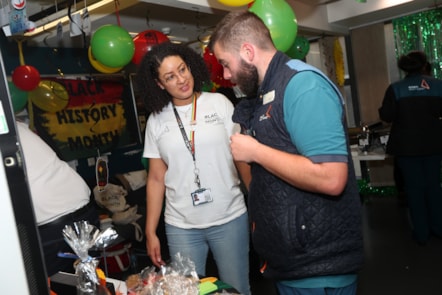 Camille Parchment, Customer Service Assistant at Birmingham New Street, and Dan Millard, Welcome Host at Birmingham New Street, discussing the raffle prizes.