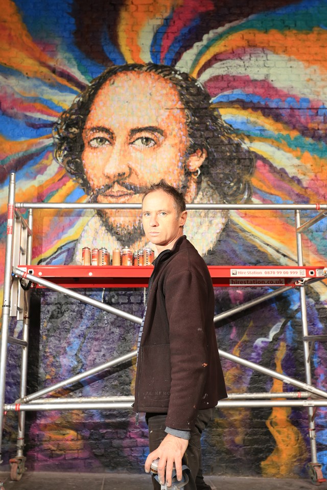 Jimmy C - portrait: Street artist Jimmy C works on a portrait of William Shakespeare on a Network Rail wall in Southwark