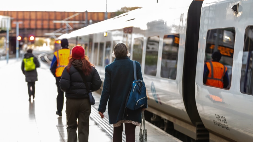 Image shows two customers boarding a Northern train