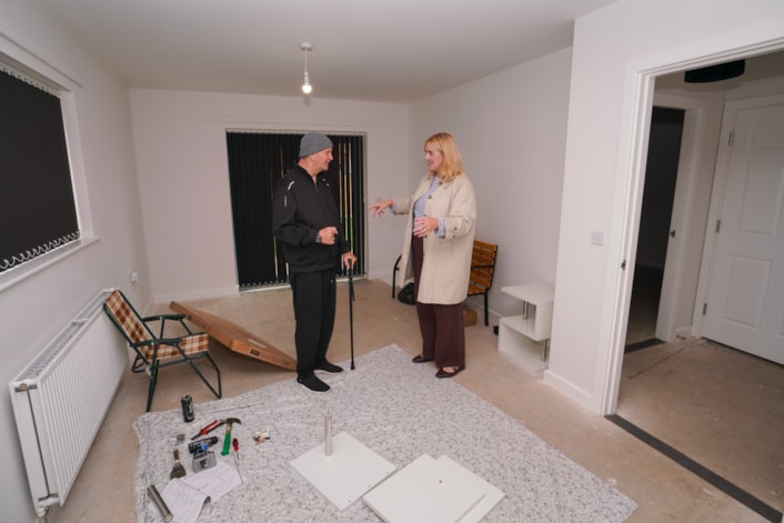 Ambertons 4: Councillor Jess Lennox, Leeds City Council’s executive member for housing, with tenant Paul Bennett at his new home, where the furniture is currently taking shape.