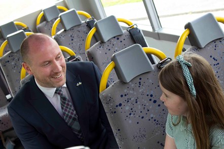Cabinet Secretary Neil Gray MSP meeting Charley Riley on Bus Lightyear