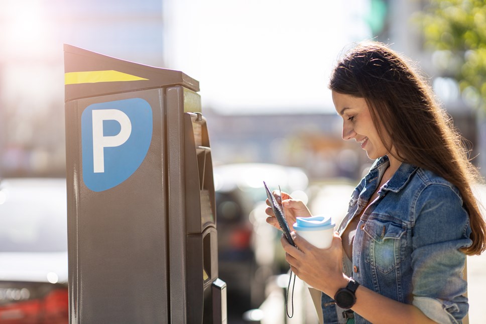 woman and parking machine