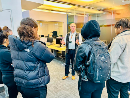 A staff member from the Council's youth justice service talking to young people from Hackney during Takeover Week about the work of the service