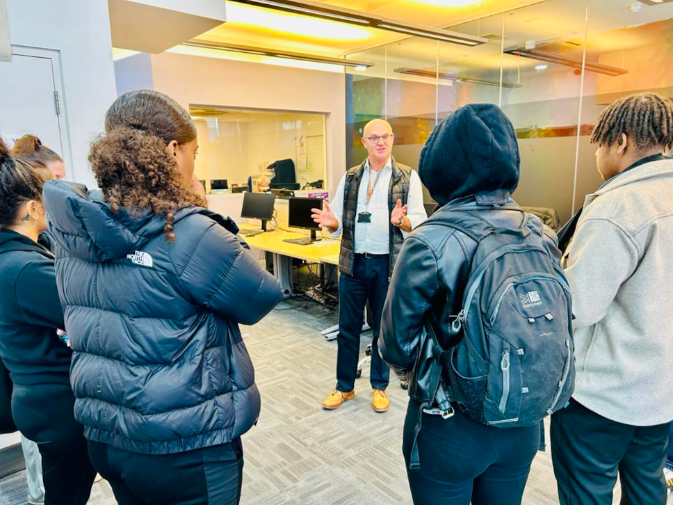 A staff member from the Council's youth justice service talking to young people from Hackney during Takeover Week about the work of the service