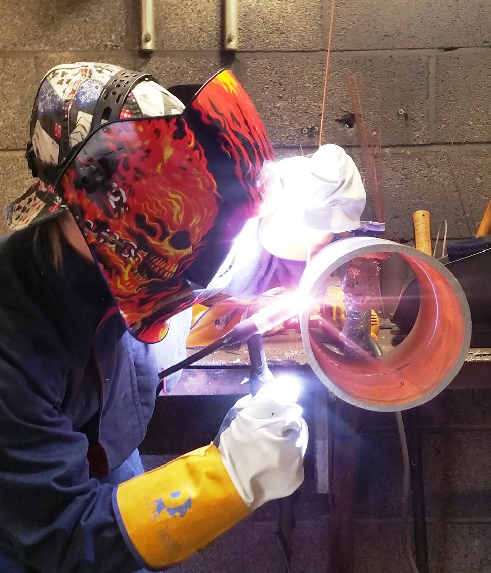 Person welding in face protection