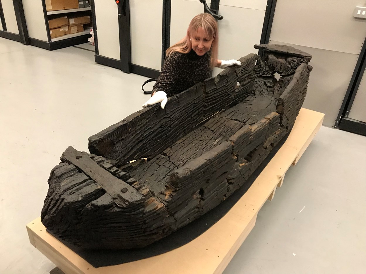 Giggleswick Tarn logboat: Kat Baxter, Leeds Museums and Galleries curator of archaeology with the centuries-old carved logboat, which dates from the 1300s. The  watercraft had lain beneath the soil for more than 500 years before being discovered by Joseph Taylor in 1863 while he was digging some drainage works near Giggleswick Tarn in North Yorkshire.