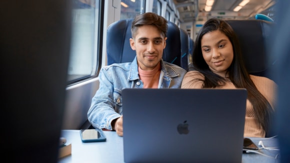 South Western Railway customers can now benefit from superfast on-board Wi-Fi with introduction of FirstGroup’s rail-5G: Two customers with laptop