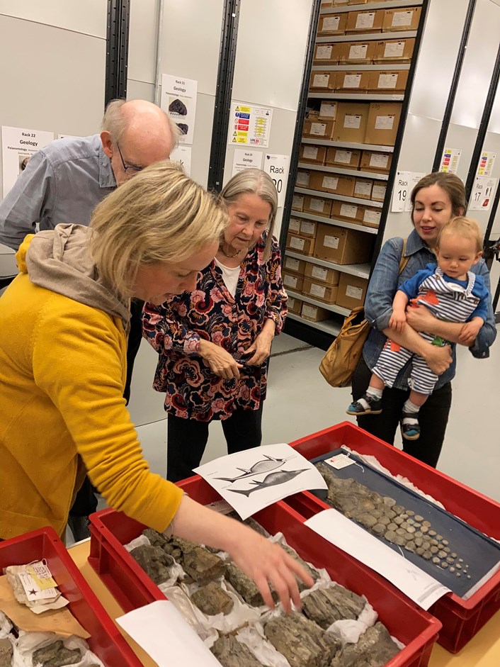 Fossil find: Curator Clare Brown (left) shows Pauline's family the impressive fossilised remains of an Ichthyosaur which Pauline found on a beach in Whitby in 1949 and which  now stored at the Leeds Discovery Centre.